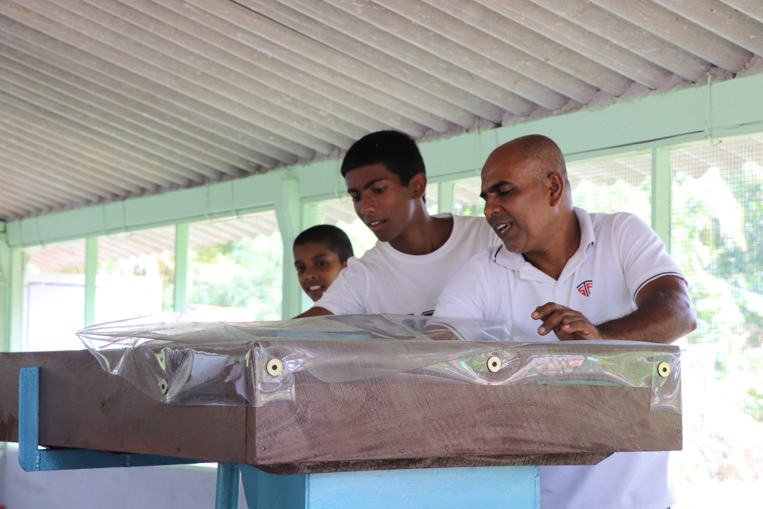 Community volunteers inspecting freshly pressed coconut oil produced at the Vimukthi Foundation agricultural project