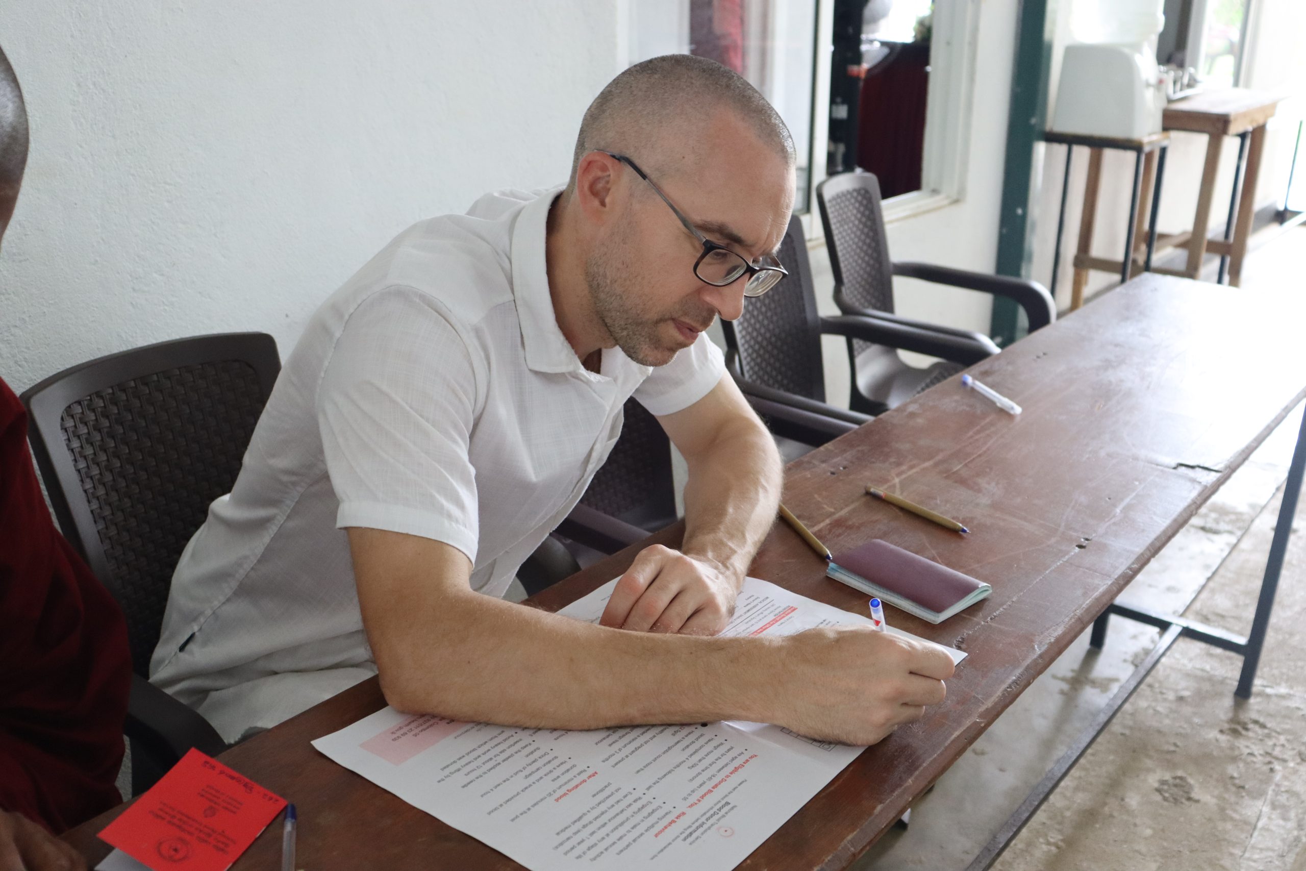 Volunteer completing donor registration form at the Vimukthi Foundation blood donation campaign