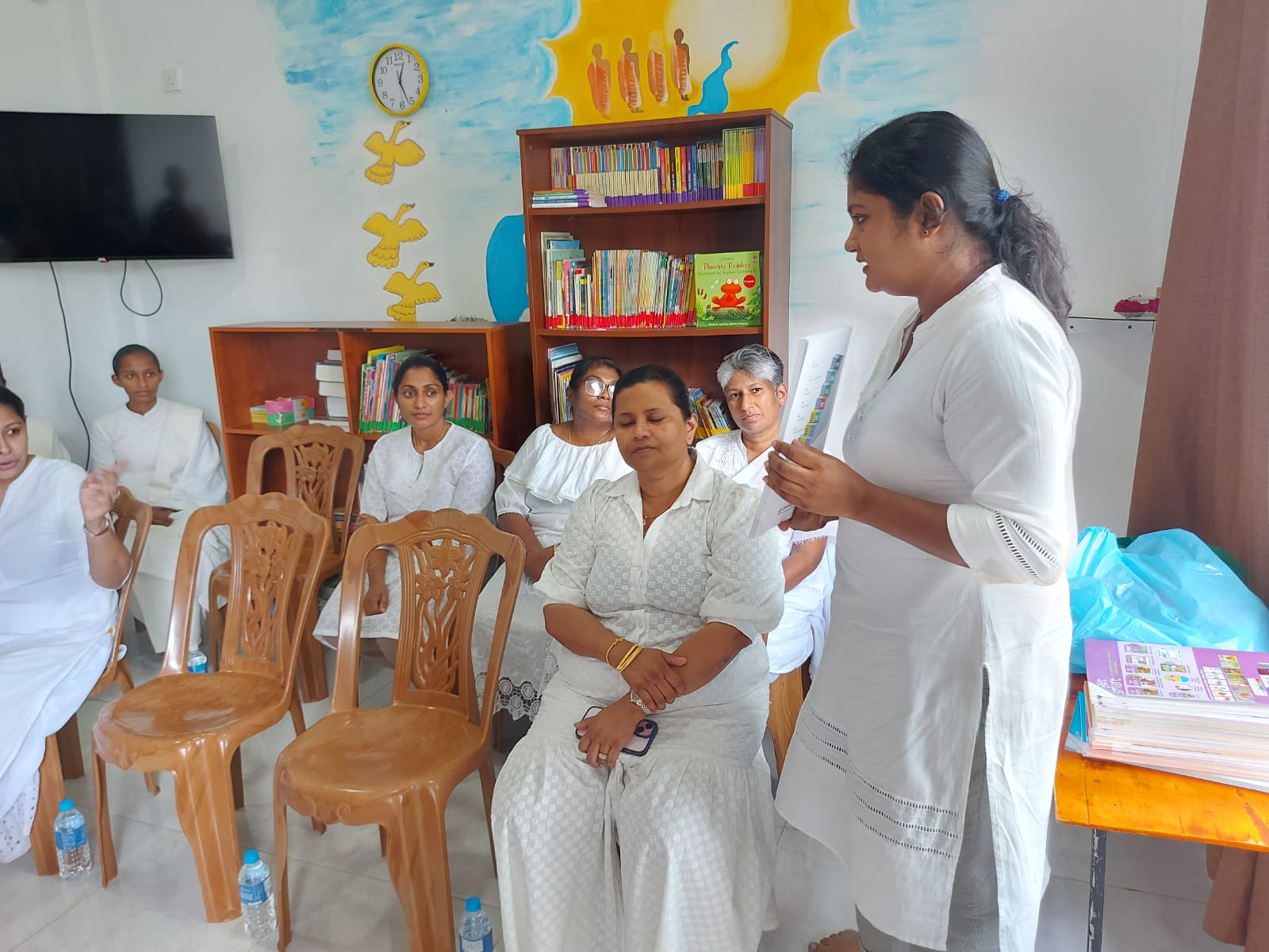 Lecturer addressing staff during the English syllabus donation program at Noble International School