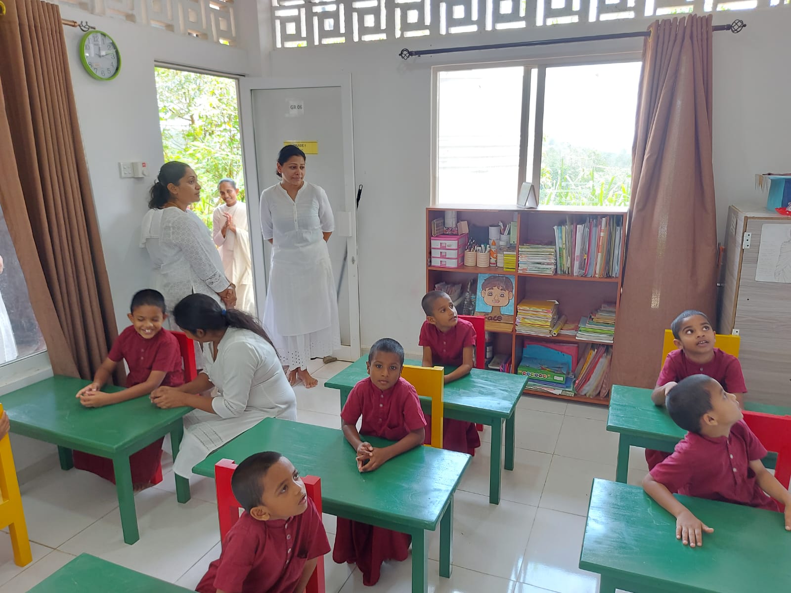 Students seated at donated green desks in a primary classroom at Noble International School Sri Lanka