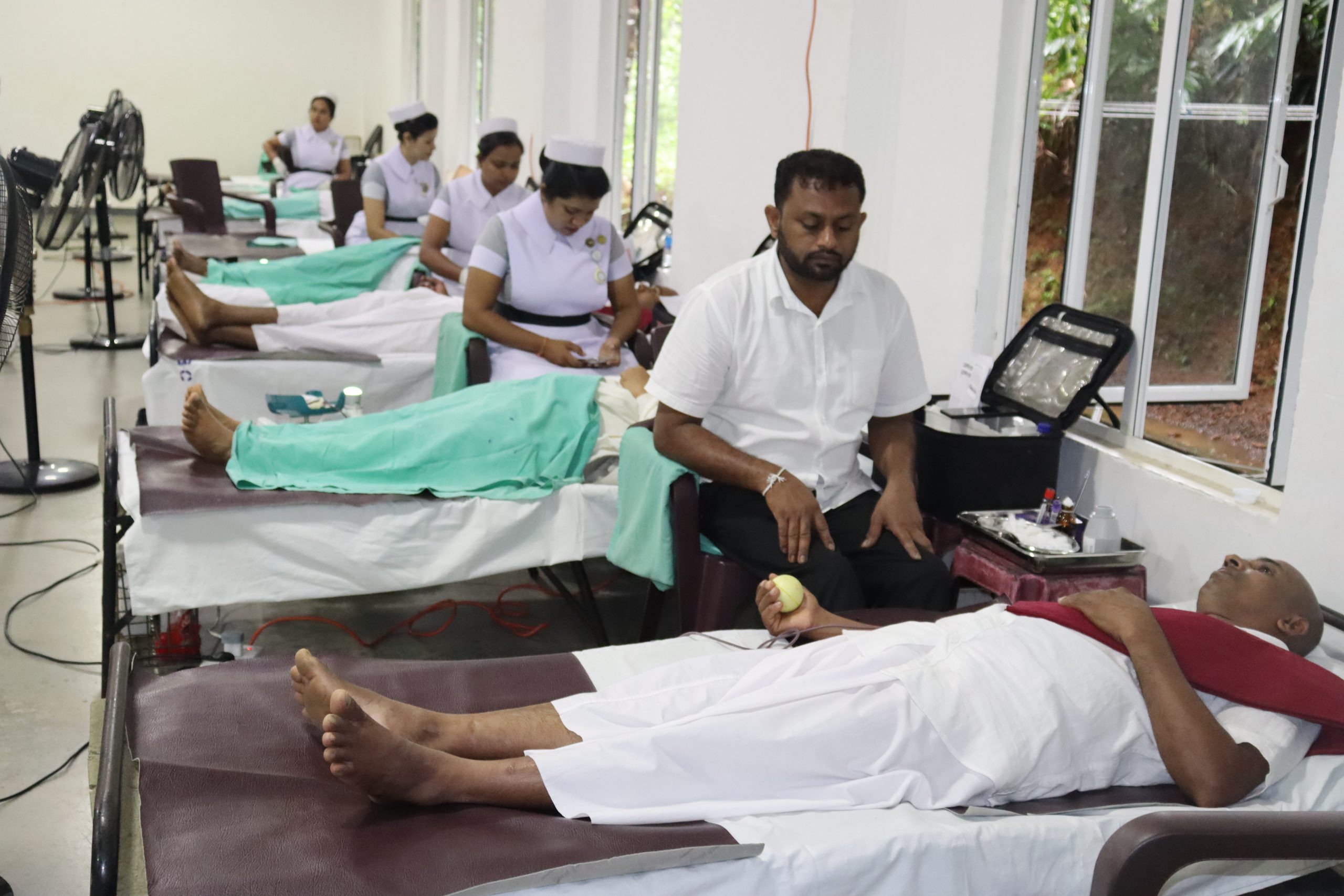 Volunteers donating blood on medical beds during the Vimukthi Foundation blood donation campaign in Sri Lanka